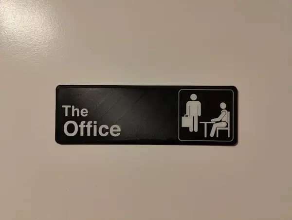 The door to my home office with a 3D printed sign that says 'The Office'