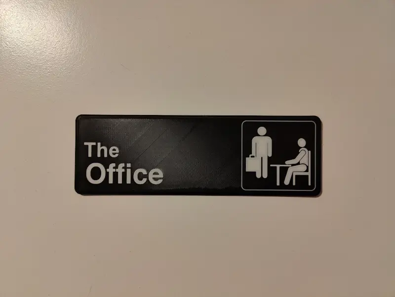The door to my home office with a 3D printed sign that says 'The Office'