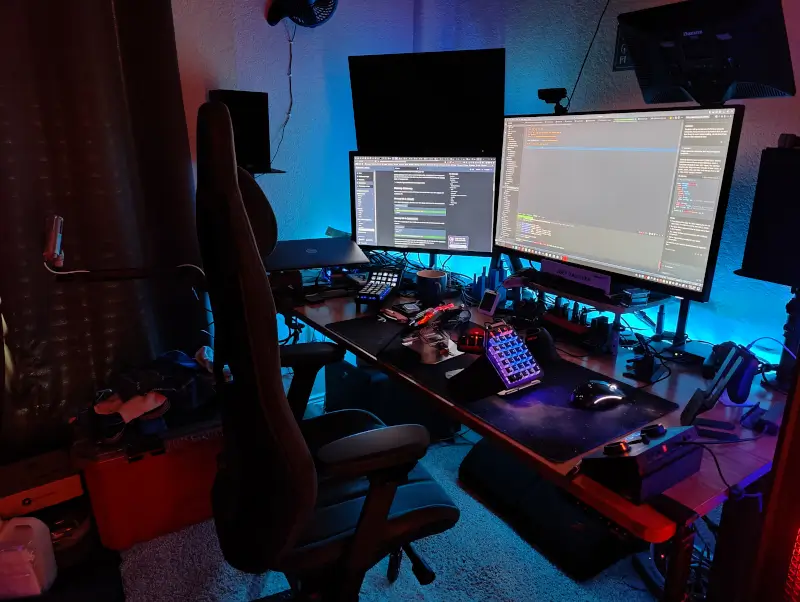a home office setup with desk, chair, and monitors