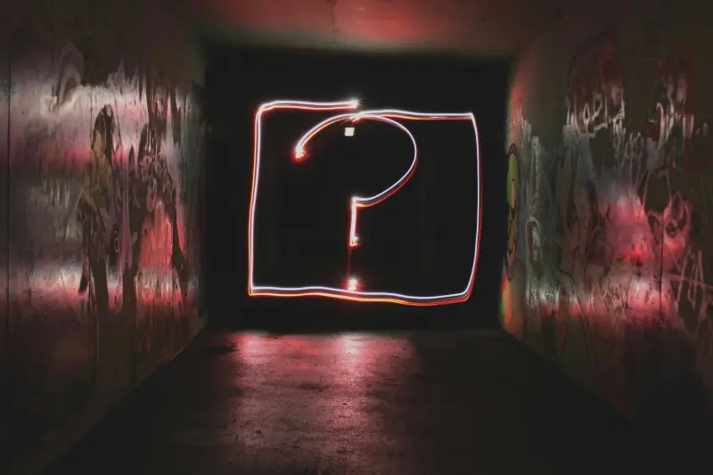 room with an illuminated question mark