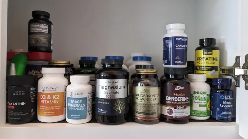 several supplement bottles in a cabinet